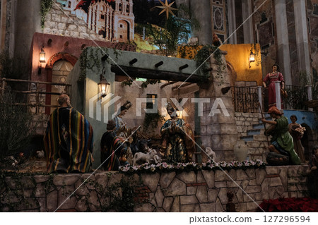 Detailed Christmas nativity scene with figures of Mary Joseph Baby Jesus Three Wise Men and animals set inside Saint Peters Basilica Vatican City during holiday season with rich architectural backdrop 127296594