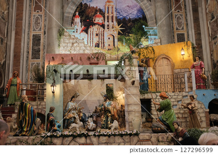 Detailed Christmas nativity scene with figures of Mary Joseph Baby Jesus Three Wise Men and animals set inside Saint Peters Basilica Vatican City during holiday season with rich architectural backdrop 127296599