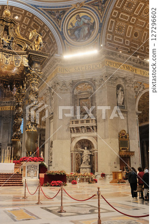 Ornate Baldachin canopy over Papal Altar in Saint Peters Basilica Vatican City designed by Gian Lorenzo Bernini with twisted bronze columns red floral decorations and Latin inscriptions under grand Ornate Baldachin canopy over Papal Altar in Saint Peters Basilica Vatican City designed by Gian Lorenzo Bernini with twisted bronze columns red floral decorations and Latin inscriptions under grand 127296602