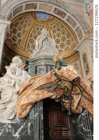Monument to Pope Alexander VII by Gian Lorenzo Bernini in Saint Peters Basilica featuring marble sculptures draped stone veil angelic figures and papal symbols under golden niche 127296626