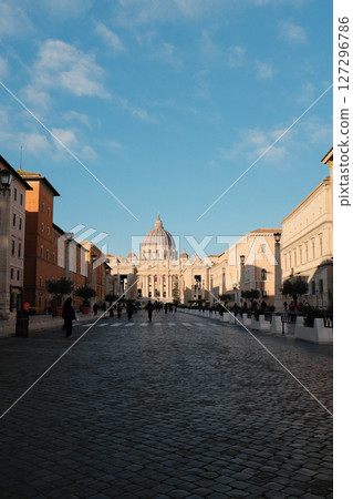 Morning view of Saint Peters Basilica Vatican City with symmetrical Renaissance architecture tourist walking in front historical religious landmark. High quality photo Morning view of Saint Peters Basilica Vatican City with symmetrical Renaissance architecture tourist walking in front historical religious landmark. High quality photo 127296786