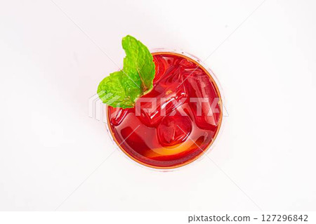 vibrant red citrus cocktail with blood orange slice and fresh mint served in clear glass over ice on white background. High quality photo vibrant red citrus cocktail with blood orange slice and fresh mint served in clear glass over ice on white background. High quality photo 127296842