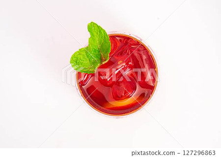 vibrant red citrus cocktail with blood orange slice and fresh mint served in clear glass over ice on white background. High quality photo vibrant red citrus cocktail with blood orange slice and fresh mint served in clear glass over ice on white background. High quality photo 127296863