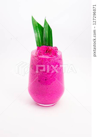 vibrant pink smoothie served in transparent glass with green tropical leaf garnish on white background dragon fruit. High quality photo vibrant pink smoothie served in transparent glass with green tropical leaf garnish on white background dragon fruit. High quality photo 127296871