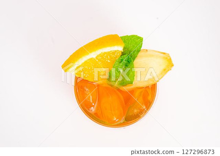 refreshing orange citrus cocktail with sliced lemon and mint leaves served in clear glass over ice on white background. High quality photo refreshing orange citrus cocktail with sliced lemon and mint leaves served in clear glass over ice on white background. High quality photo 127296873