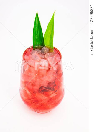 red berry cocktail served in clear glass with crushed ice and green tropical leaves isolated on white background. High quality photo red berry cocktail served in clear glass with crushed ice and green tropical leaves isolated on white background. High quality photo 127296874