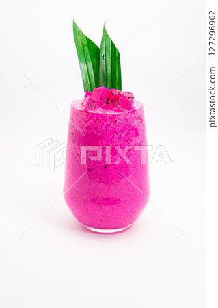 vibrant pink smoothie served in transparent glass with green tropical leaf garnish on white background dragon fruit. High quality photo vibrant pink smoothie served in transparent glass with green tropical leaf garnish on white background dragon fruit. High quality photo 127296902