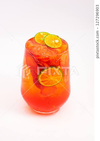 bright red fruit cocktail with sliced kumquats and ice served in transparent glass on clean white background. High quality photo bright red fruit cocktail with sliced kumquats and ice served in transparent glass on clean white background. High quality photo 127296903