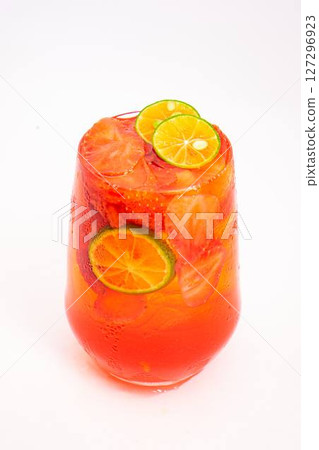 bright red fruit cocktail with sliced kumquats and ice served in transparent glass on clean white background. High quality photo bright red fruit cocktail with sliced kumquats and ice served in transparent glass on clean white background. High quality photo 127296923