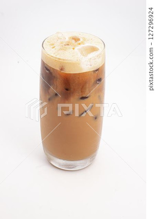 iced coffee with cream and ice cubes served in tall clear glass with foamy top photographed on white background. High quality photo 127296924