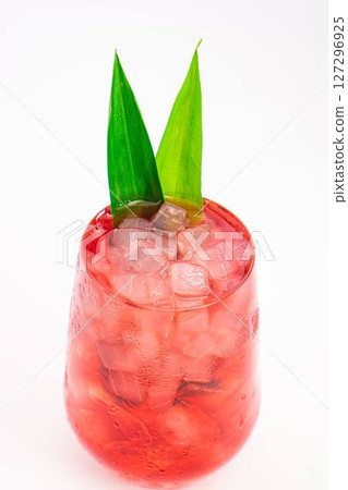 red berry cocktail served in clear glass with crushed ice and green tropical leaves isolated on white background. High quality photo red berry cocktail served in clear glass with crushed ice and green tropical leaves isolated on white background. High quality photo 127296925