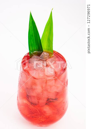 red berry cocktail served in clear glass with crushed ice and green tropical leaves isolated on white background. High quality photo red berry cocktail served in clear glass with crushed ice and green tropical leaves isolated on white background. High quality photo 127296971
