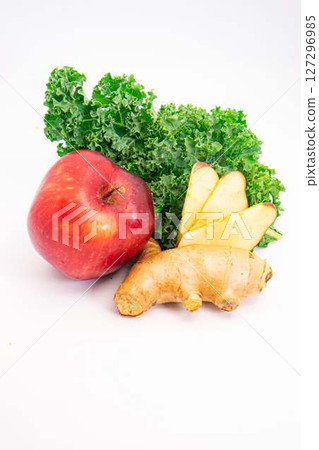 fresh red apple ginger root and curly kale leaves arranged on clean white background for healthy food and juice ingredients concept. High quality photo 127296985