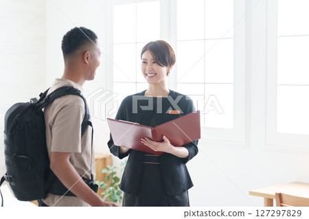 Asian hotel staff and foreign tourists 127297829