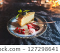 Piece of cheesecake with fresh berries and mint on dark background 127298641