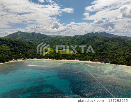 Tropical Beach with ocean waves and turquoise sea water with sun reflection. El Nido, Palawan. Philippines. 127298935