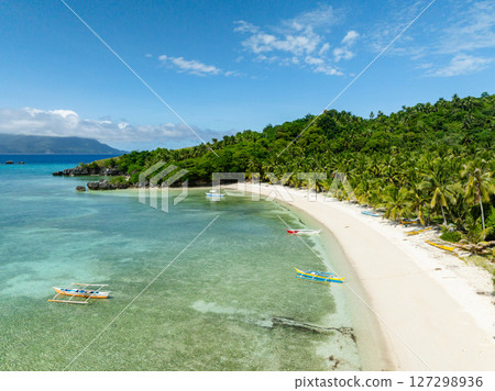 Boats floating over the clear water in white sandy beach in Cobrador Island. Romblon, Philippines. Boats floating over the clear water in white sandy beach in Cobrador Island. Romblon, Philippines. 127298936