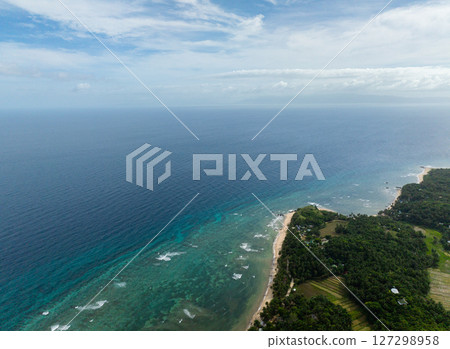 Blue sea with waves and corals. Paddy fields in Santa Fe, Tablas, Romblon, Philippines. 127298958