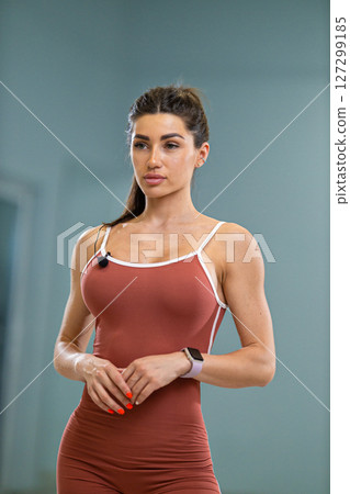 Sporty girl announcer stands confidently in a fitness studio wearing athletic attire She is poised to share health and fitness insights, ready to engage the audience with her energy Sporty girl announcer stands confidently in a fitness studio wearing athletic attire She is poised to share health and fitness insights, ready to engage the audience with her energy 127299185