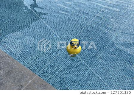 rubber inflatable toy floating in blue pool, clear water 127301320