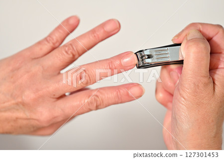 Senior cutting nails 127301453