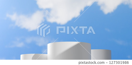 White cylindrical podiums of varying heights are set against a clear blue sky with soft clouds. Minimalist outdoor scene provides a clean and expansive backdrop, Showcasing products open air themes. White cylindrical podiums of varying heights are set against a clear blue sky with soft clouds. Minimalist outdoor scene provides a clean and expansive backdrop, Showcasing products open air themes. 127301986