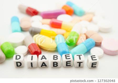 Diabetes word with pills and capsules medical drug. Diabetes word with pills and capsules medical drug. 127302048