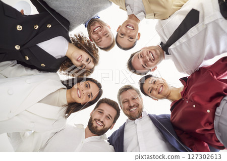 Bottom view portrait of a joyful smiling business people looking down into camera in office. Bottom view portrait of a joyful smiling business people looking down into camera in office. 127302613
