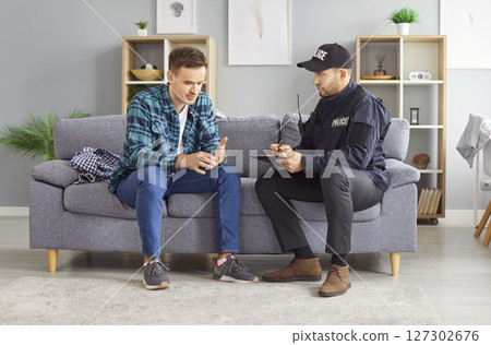 Detective Interviewing Witness Or Victim Of Home Burglary At Crime Scene Detective Interviewing Witness Or Victim Of Home Burglary At Crime Scene 127302676