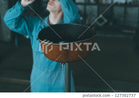Oil drain tray in an automobile repair shop Oil drain tray in an automobile repair shop 127302737