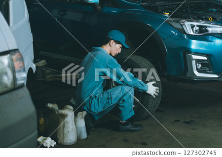 Automobile mechanic exchanging tires Automobile mechanic exchanging tires 127302745