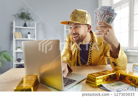 Rich Man Celebrating Financial Success With Cash And Laptop 127303035