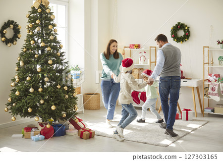 Family having fun and dancing at home celebrating New Year or Christmas with kids. 127303165