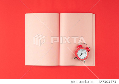 Pink notepad on a red background. 127303173