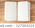 Open brown notebook on wooden background. 127303224