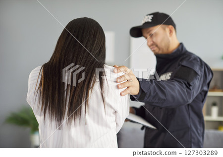 Policeman, officer police man in uniform trying to help, calm down female victim after home abuse Policeman, officer police man in uniform trying to help, calm down female victim after home abuse 127303289