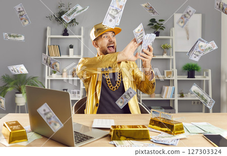 Man Celebrating Financial Success, Making It Rain Cash While Working On Laptop Man Celebrating Financial Success, Making It Rain Cash While Working On Laptop 127303324