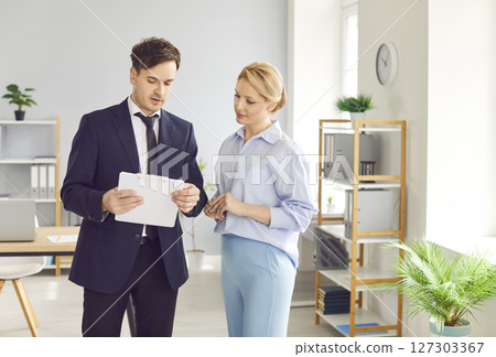 Coworkers Talking During Meeting In Office 127303367