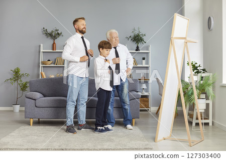 Family of father, child boy and grandfather standing at home and looking at the mirror together. Family of father, child boy and grandfather standing at home and looking at the mirror together. 127303400