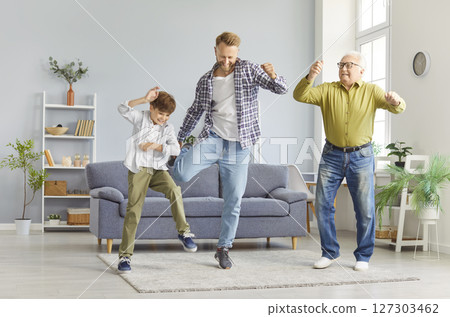 Grandfather, Father, And Son Dancing To Music And Having Fun At Home Together Grandfather, Father, And Son Dancing To Music And Having Fun At Home Together 127303462