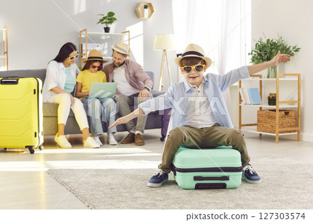 Happy Boy Showing Flight During Preparing For Summer Vacation Or Trip 127303574