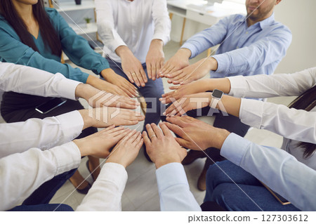 Business people stretched out their hands connecting in a circle Business people stretched out their hands connecting in a circle 127303612