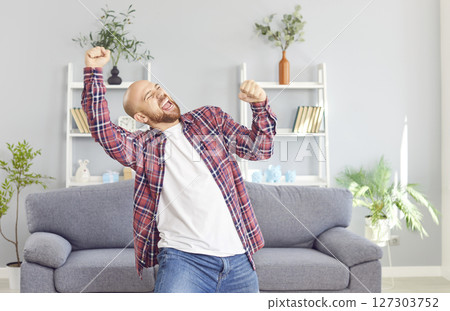 Happy Bald Man Celebrating Success At Home 127303752