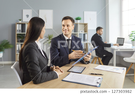Business Colleagues In Office Engaged In Productive Finance Conversation 127303982