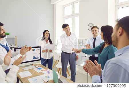 A group of business people thanks the speaker for his presentation A group of business people thanks the speaker for his presentation 127304095