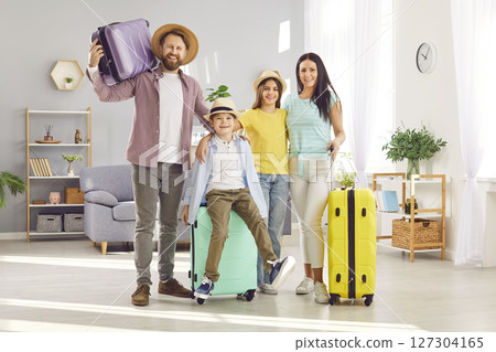 Happy family standing with luggage going to vacation holiday trip in living room at home. 127304165