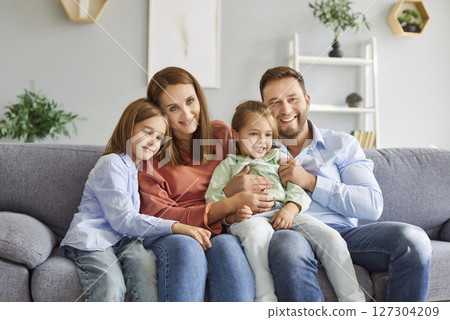 Happy Family With Children Embracing On The Couch At Home Happy Family With Children Embracing On The Couch At Home 127304209