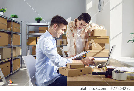 Colleagues Conducting Warehouse Inventory For Online Shop Colleagues Conducting Warehouse Inventory For Online Shop 127304252