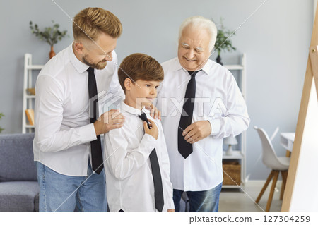 Happy father, grandfather and child boy in shirts and ties getting ready for family event Happy father, grandfather and child boy in shirts and ties getting ready for family event 127304259