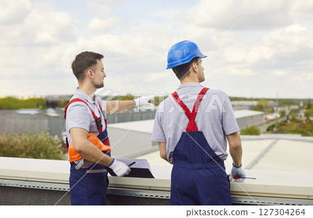 Builders Planning Construction Site From Roof Builders Planning Construction Site From Roof 127304264